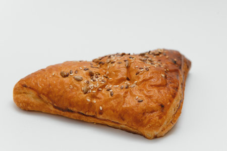 Puff pastry triangle on white background.