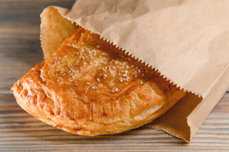 Puff pastry filled with jam on a wooden background.の写真素材