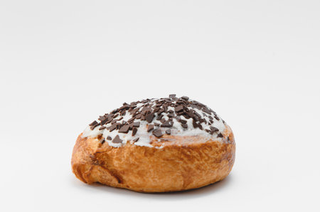 freshly baked sweet cinnamon roll isolated on white background, top view.