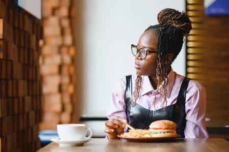 african american woman with vegan meatless burger meal.の写真素材