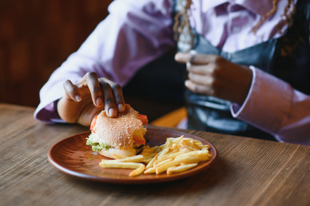african american woman with vegan meatless burger meal.