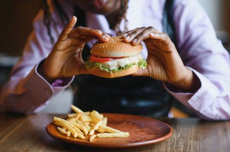 african american woman with vegan meatless burger meal.の写真素材