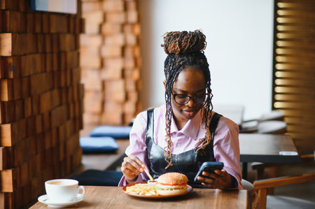 african american woman with vegan meatless burger meal.の写真素材
