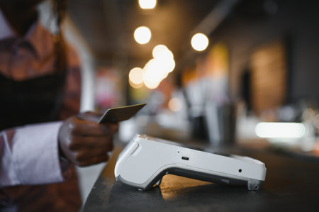 female customer holding credit card near nfc technology on counter, client make transaction pay bill...