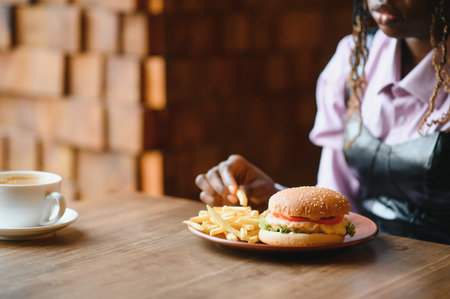 african american woman with vegan meatless burger meal.