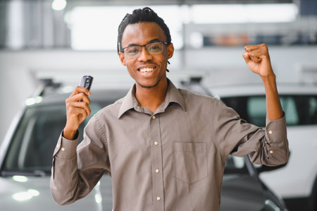 Young African American man is choosing a new vehicle in car dealership.の写真素材