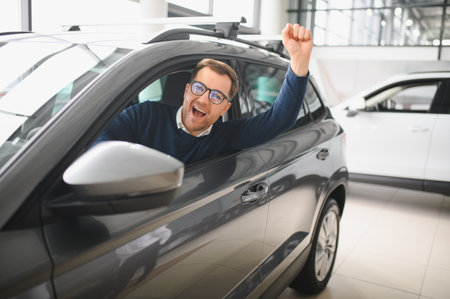 Man buying a car at a showroom.の写真素材
