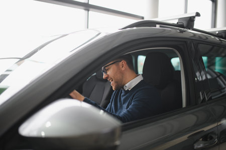 Man buying a car at a showroom.の写真素材
