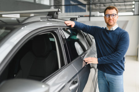 Handsome bearded buyer in casual wear in dealership.