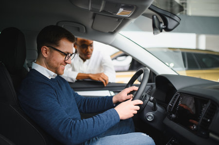 Car Sales Manager Showing Auto To Buyer Standing In Luxury Automobile Dealership Store.の写真素材