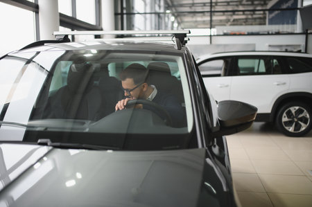 Man buying a car at a showroom.の写真素材