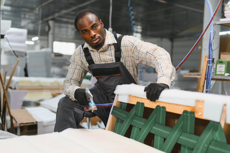 Carpenter skillfully assembling a sofa in a furniture factory, showcasing craftsmanship and...