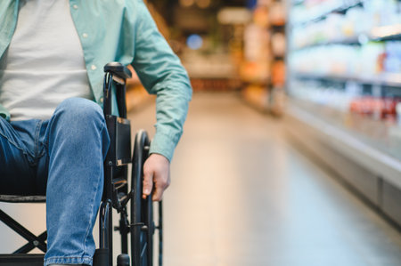 Man navigating the supermarket aisle in a wheelchair, selecting groceries and enjoying independence...