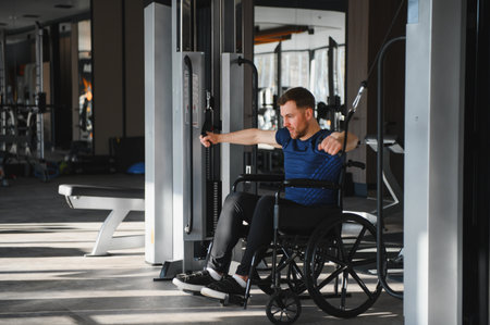 Man with disability athlete exercising with cable weights in a modern gym, demonstrating strength...