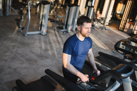 Man using gym equipment for rehabilitation and fitness, emphasizing strength and determination in a...