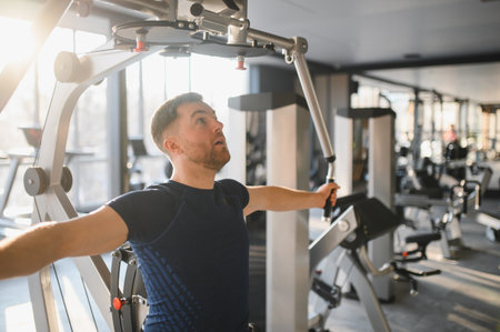 Determined man using specialized equipment for upper body workout, demonstrating resilience and...