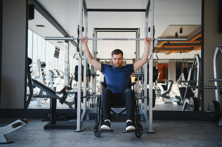 Man with disability exercising with barbell in modern gym, demonstrating strength, resilience, and...