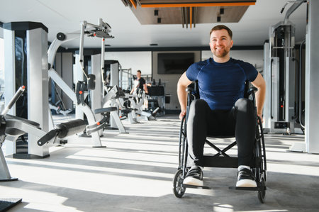 man in a wheelchair exercising in a bright gym, promoting inclusivity and active lifestyle for...