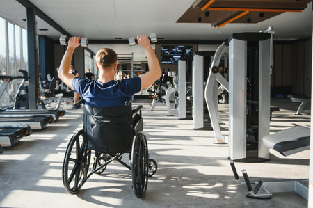 Patient lifting weights during a physical therapy session in a modern rehabilitation center,...