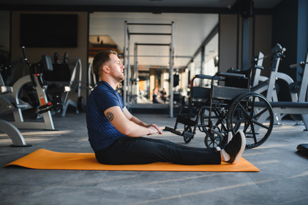 man performing stretching exercises on a mat, focusing on rehabilitation and recovery in a modern...