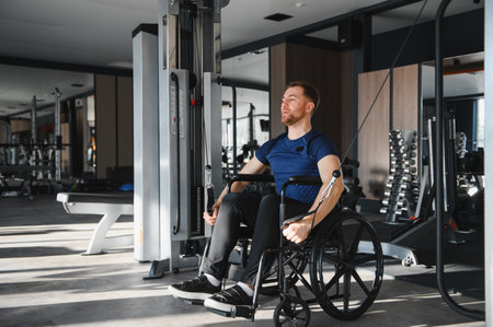 Man in wheelchair exercising with cable weights in gym, demonstrating inclusivity and perseverance...