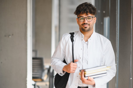 Portrait of a smiling medical student carrying books and wearing a backpack, embodying the spirit of...