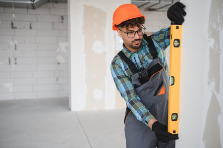 Arab builder using a spirit level ensures perfect vertical alignment during house construction