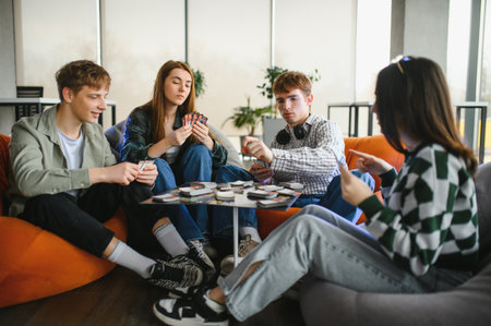 Four young adults enjoying their free time playing a board game in a comfortable, modern apartment