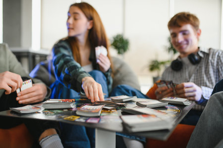 Young adults enjoying a lively card game, strategizing and having fun together in a casual home...