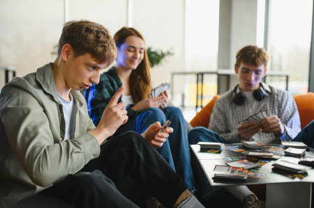 Group of young adults enjoying a lively card game, sharing laughter and creating memorable moments...
