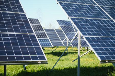 Rows of solar panels are absorbing sunlight in a green field, generating clean and sustainable...