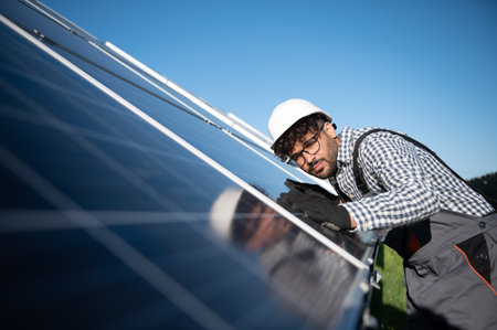 Engineer working on checking and installing solar panels in a solar power station, promoting...