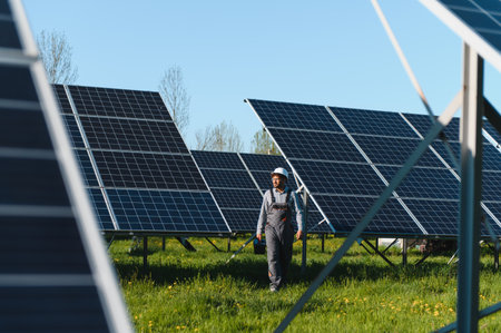 Technician in a field of solar panels, focused on installation and maintenance, highlighting...