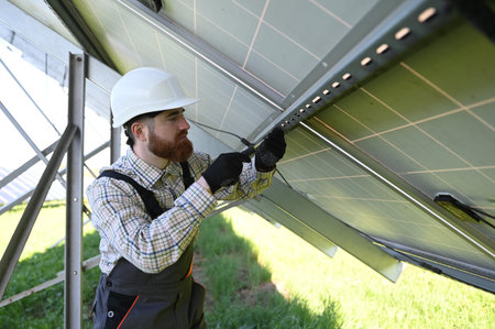 Skilled worker in protective gear installing solar panels, contributing to sustainable energy...