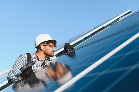 Engineer working on photovoltaic plant installing solar panels for renewable energy production