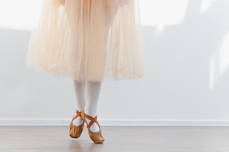 Ballerina's feet in pointe shoes during ballet class, showcasing grace and dedication in dance studioの写真素材