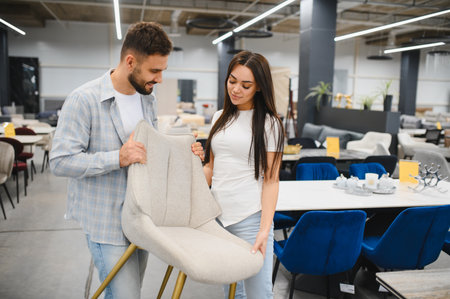 Young couple shopping furniture for their home. They are making a decision about new chairs for a dining areaの写真素材