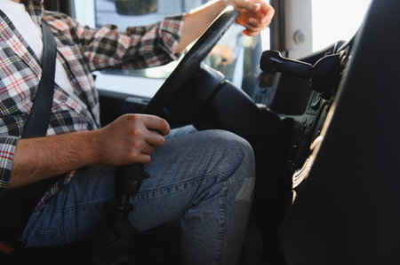 Man in plaid shirt, wearing seatbelt, operating a heavy vehicle. Focusing on transportation, safety,...