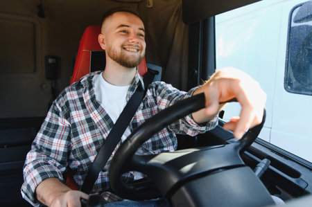 Happy young man driving a large vehicle, delivering goods through transportation network, showing...