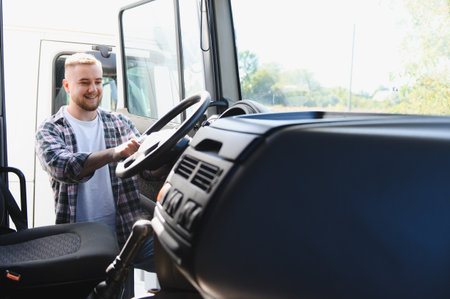 Young man smiling, starting his workday, entering the truck cabin, preparing for transport and...
