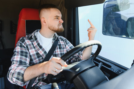 Angry man driver expressing frustration while driving a truckの写真素材