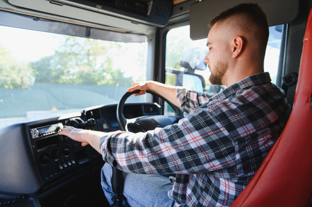 Man in plaid shirt driving a commercial truck, adjusting controls on the dashboard. Representing...