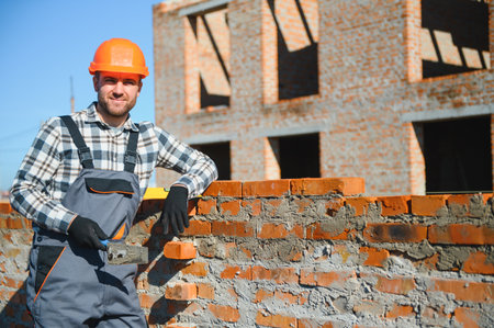 Portrait of a builder in the process of working on a construction site outdoors.の写真素材