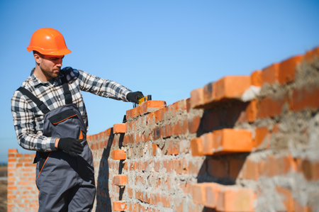 Portrait of a builder in the process of working on a construction site outdoors.の写真素材