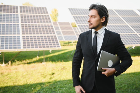 Businessman or engineer standing near solar panels.の写真素材