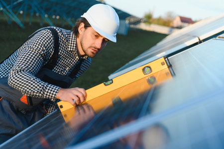 Solar panel technician installing solar panels on a sunny day.