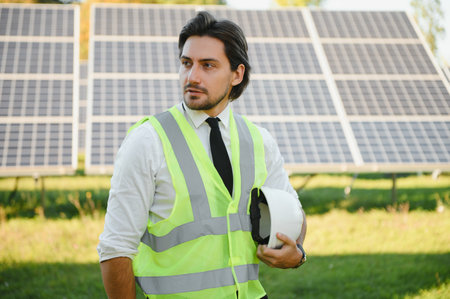 Businessman or engineer standing near solar panels.の写真素材