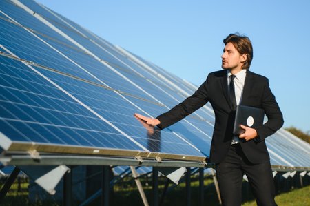 Businessman or engineer standing near solar panels.の写真素材