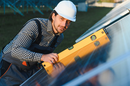 Worker installing solar panels outdoors.
