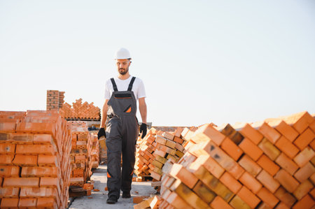 Construction worker in uniform and safety equipment have job on building.の写真素材